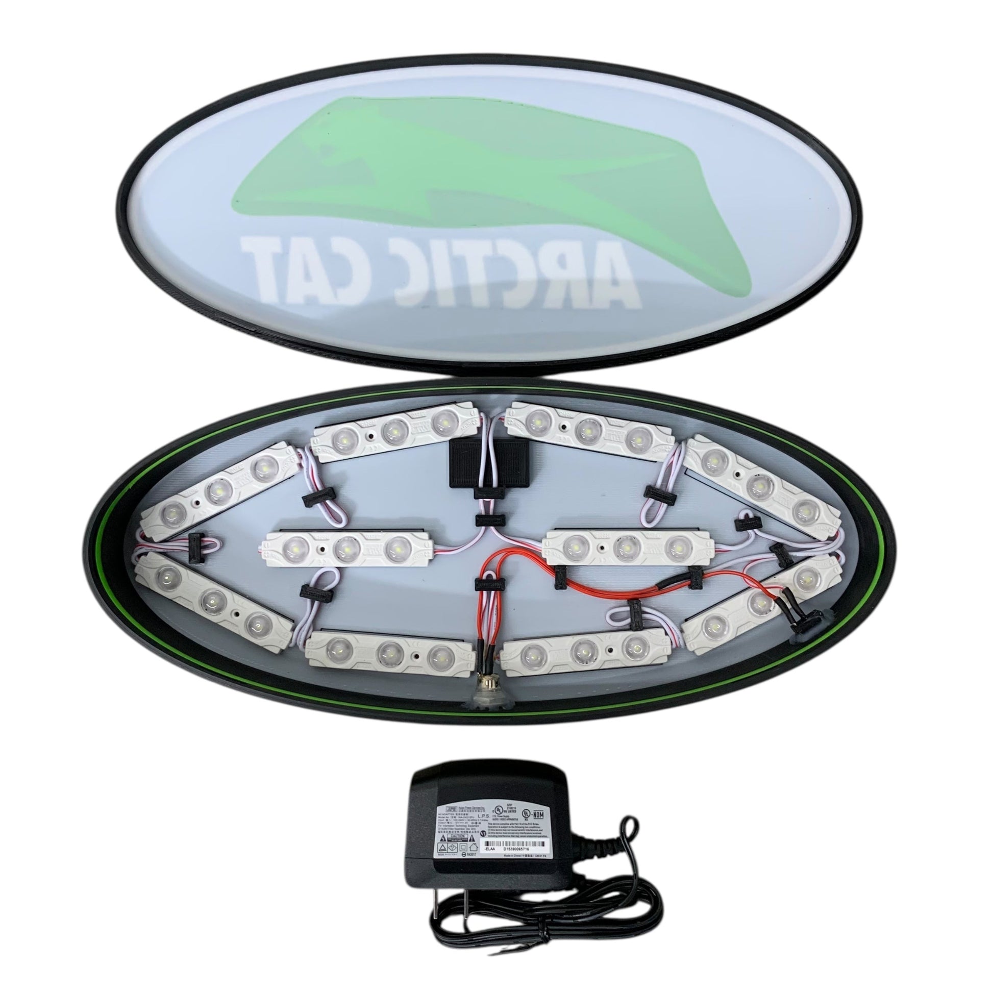 Inside of Arctic Cat LED indoor sign with a power adapter on a white background