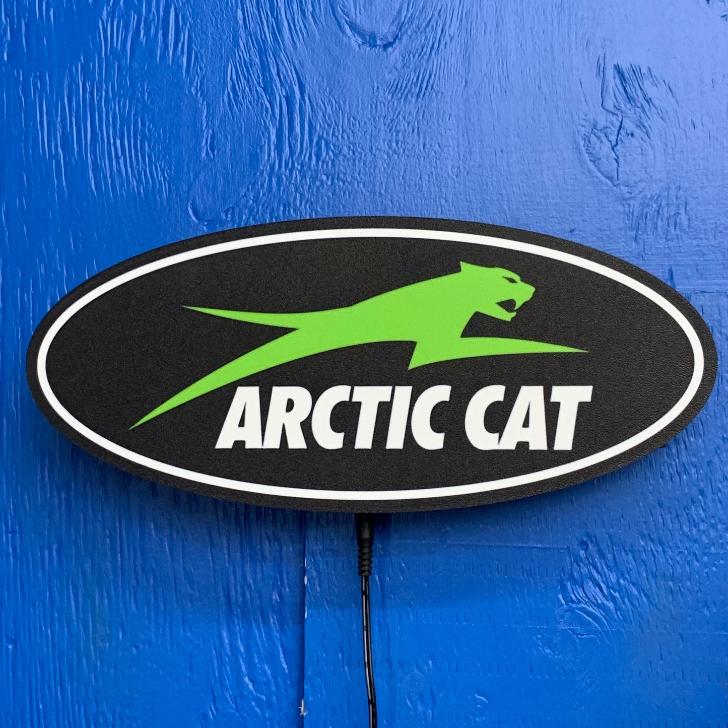 Arctic Cat LED indoor sign on a blue background