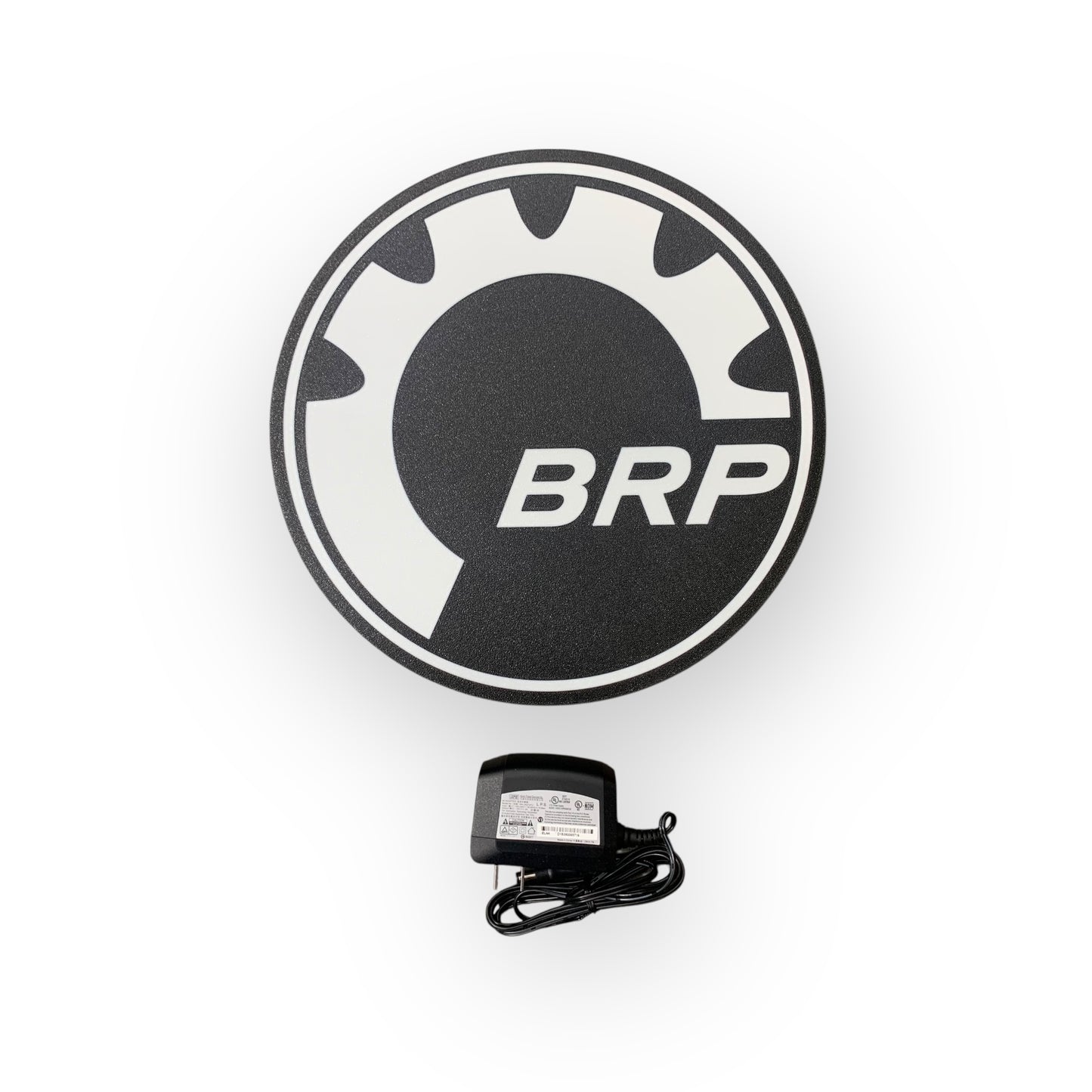 Round black and white logo with 'BRP' text on a white background on a led indoor sign