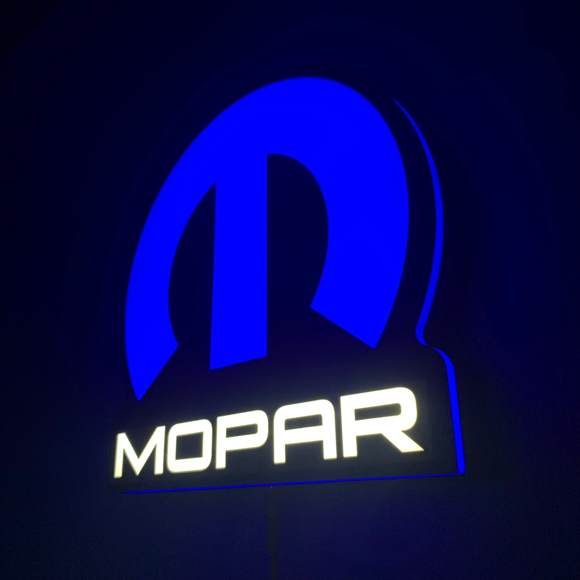 Mopar led indoor sing illuminated in blue and white on a dark background