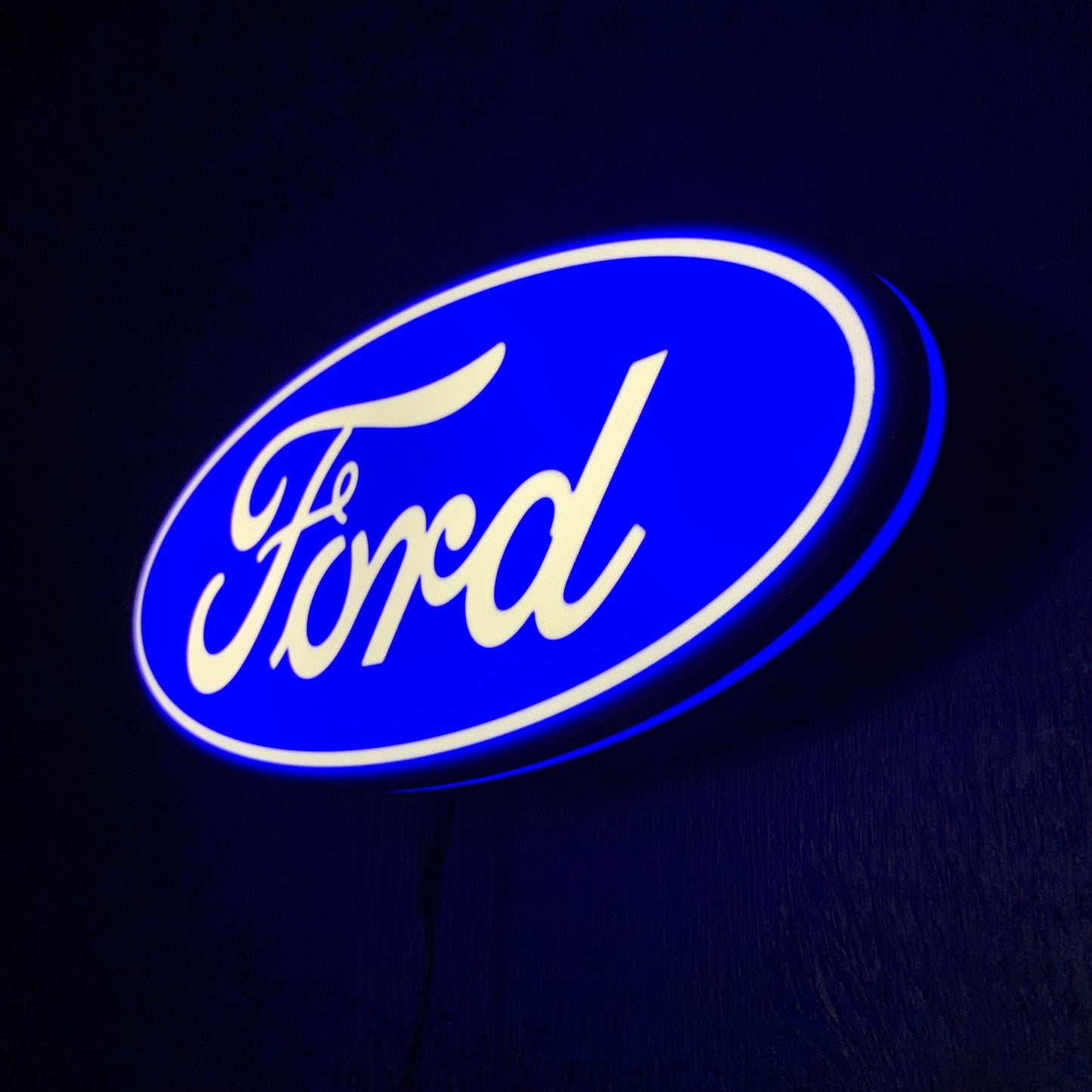 Ford led indoor sign illuminated with blue and white lights on a dark background