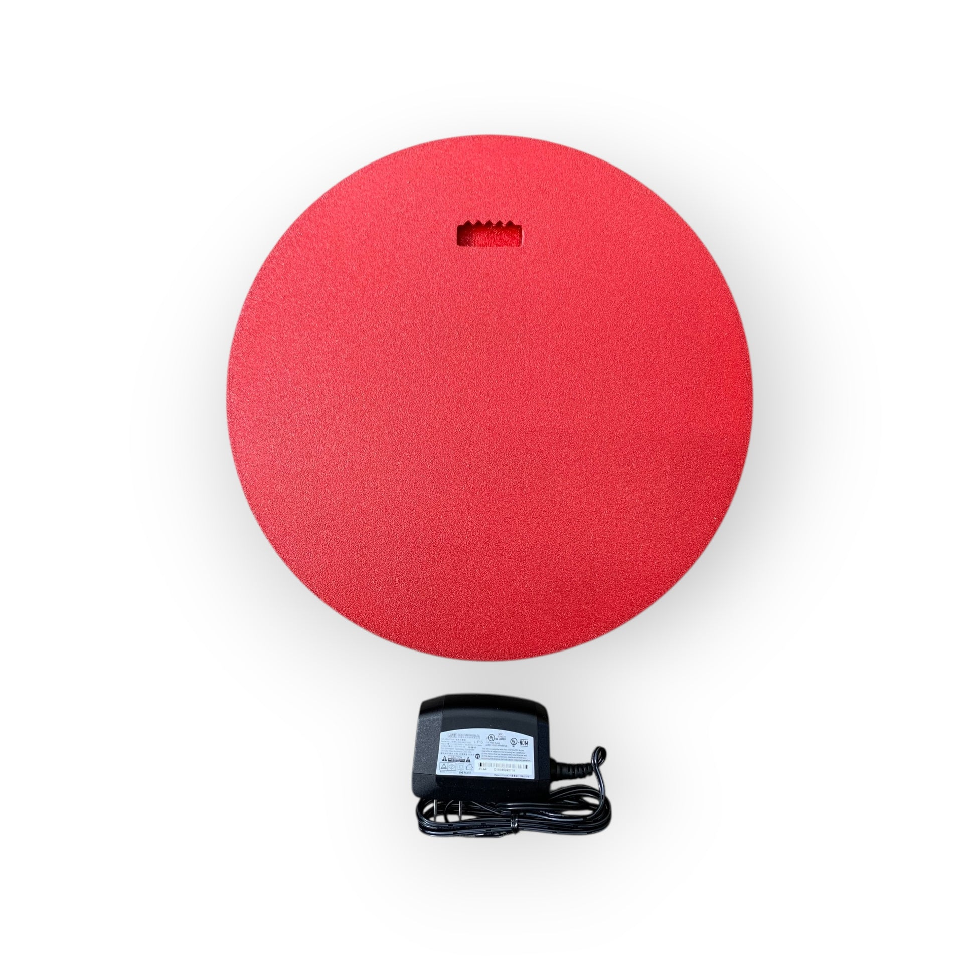 Back of red led indoor sign with a black power adapter on a white background