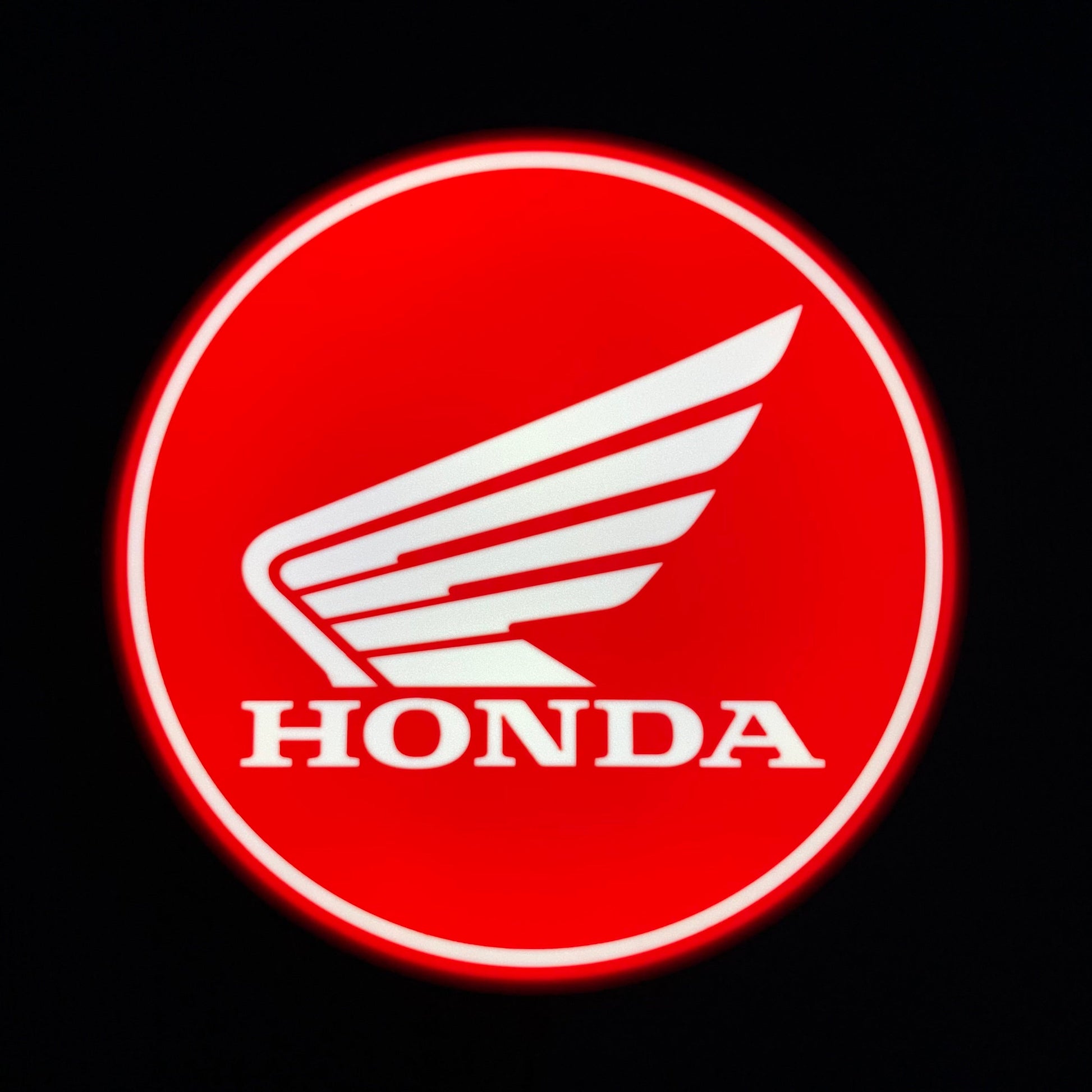 Honda led indoor sign on a red circle with a black background