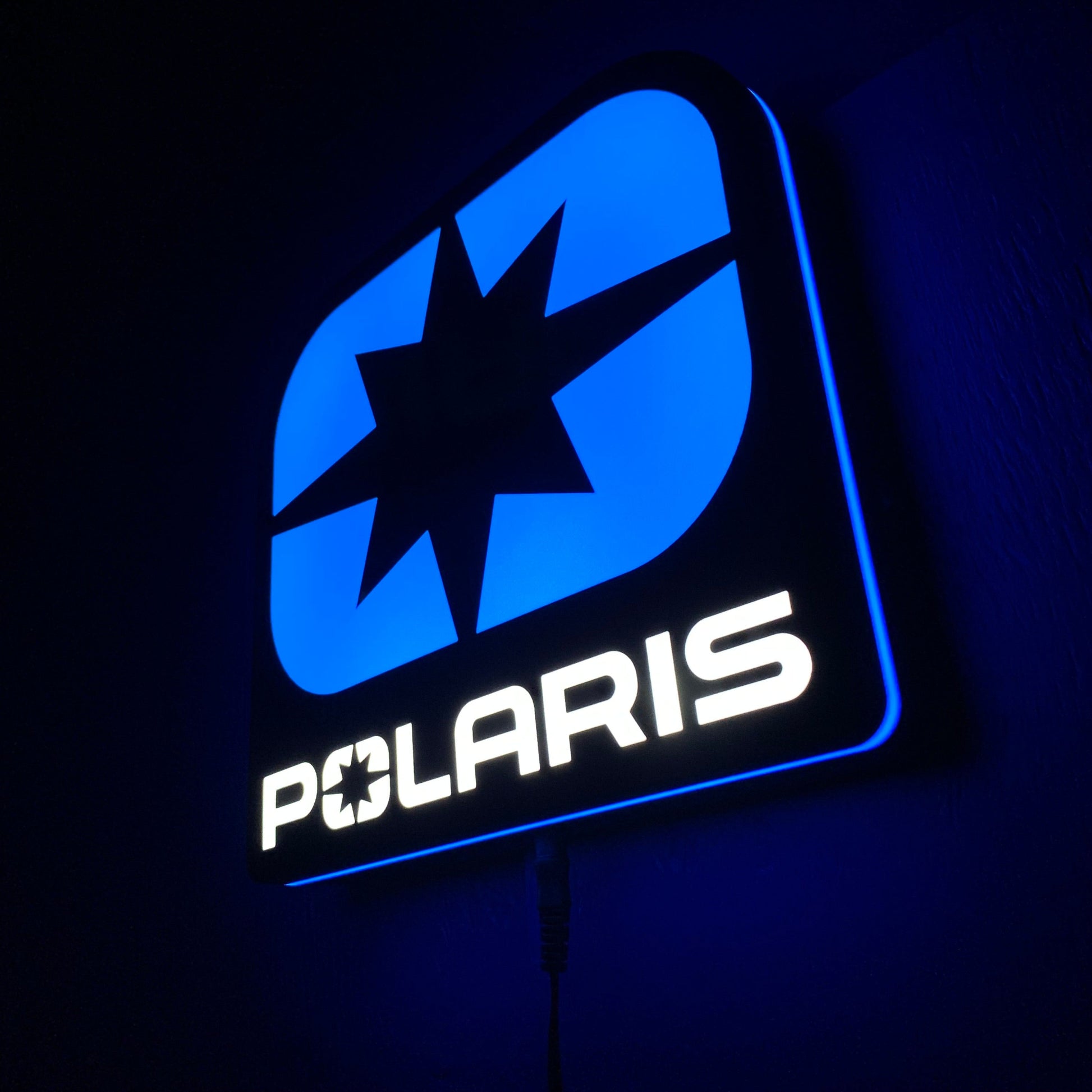 Light Blue led indoor sign with Polaris logo on a dark background