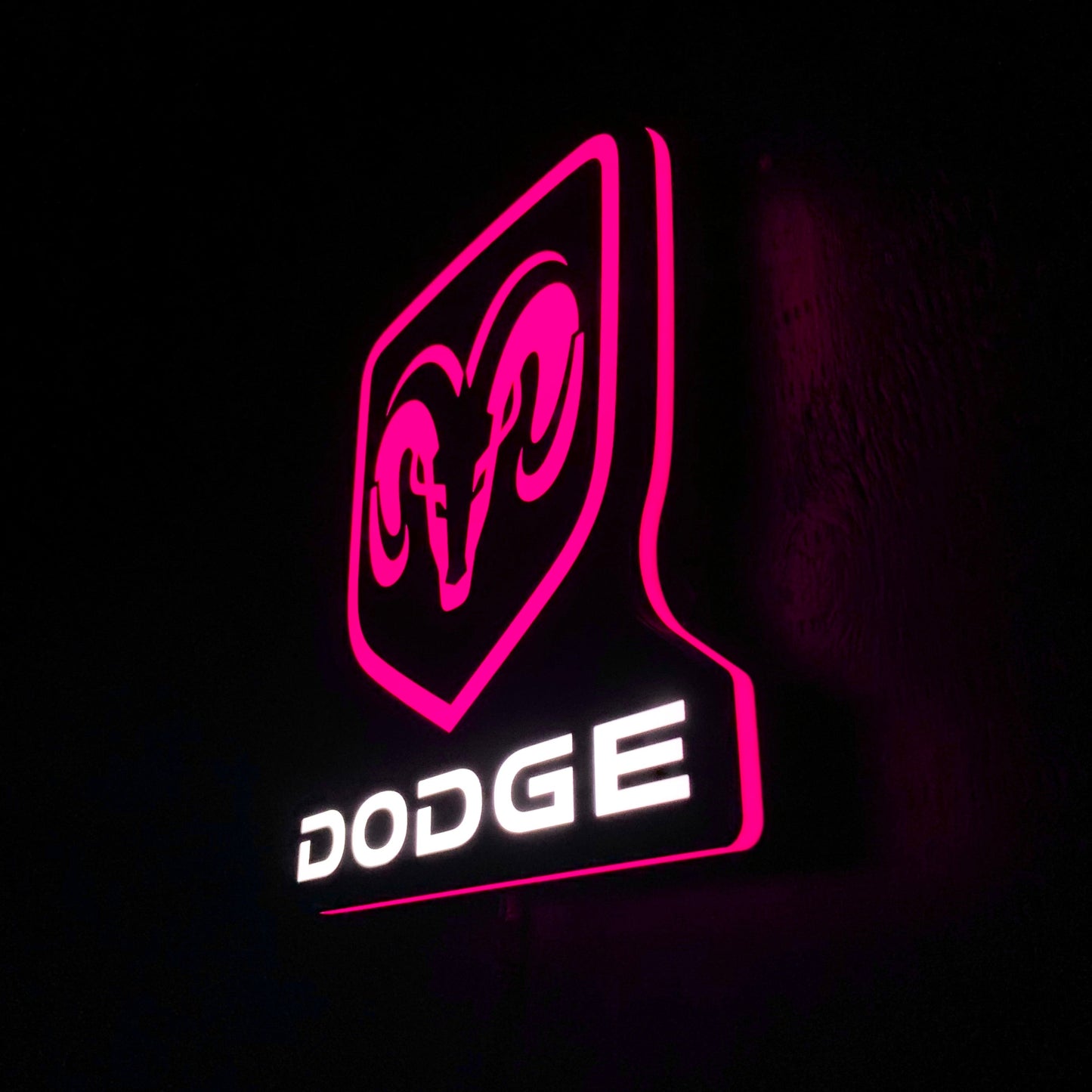 Dodge led indoor sign with pink outline on a black background
