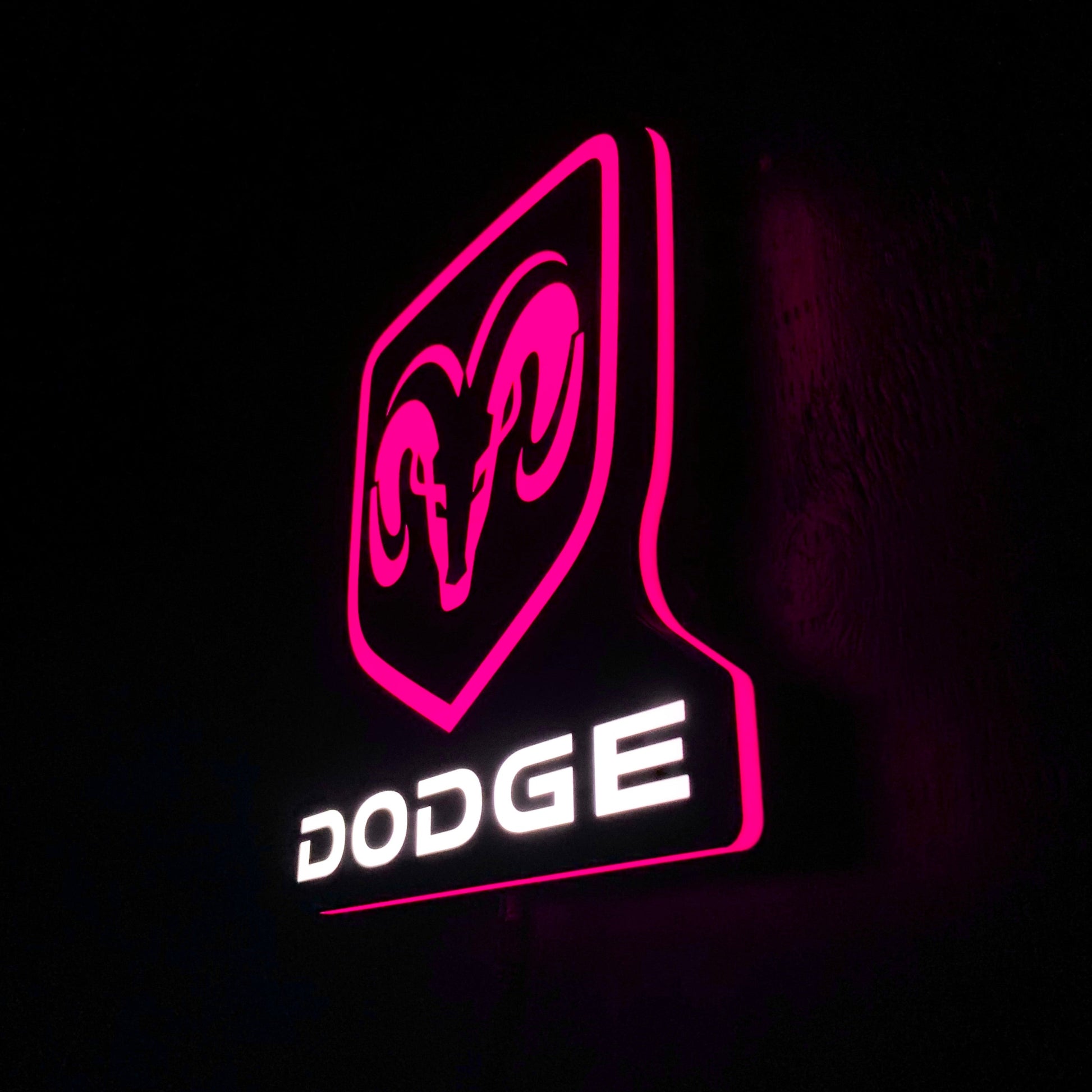 Dodge led indoor sign with pink outline on a black background