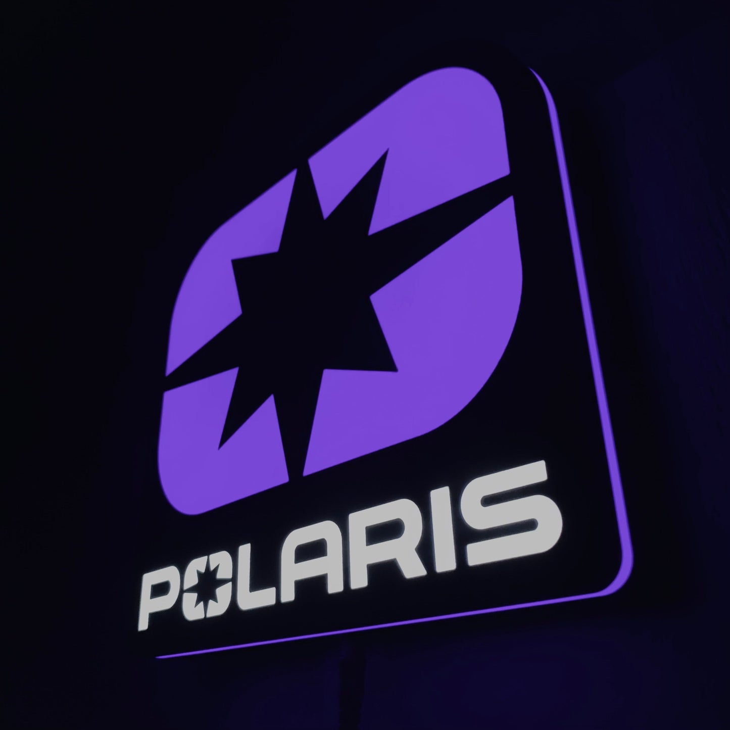 Polaris led indoor sign with a purple star design on a black background