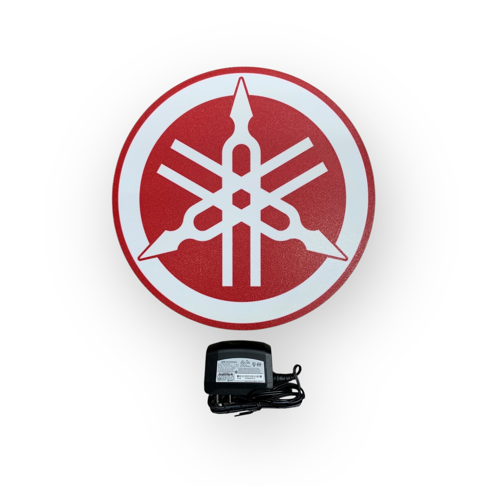 Yamaha logo on led indoor sign with a power adapter on a white background