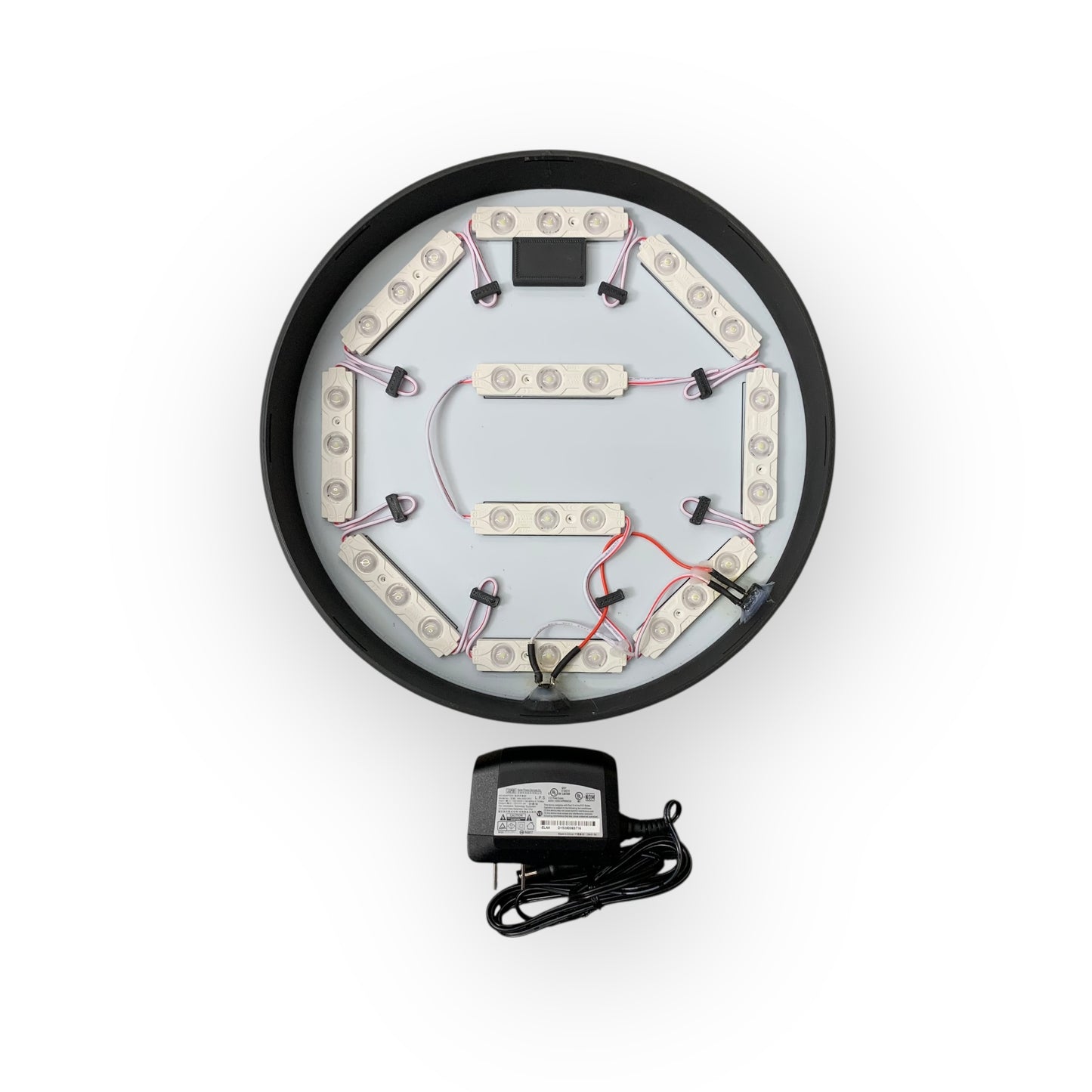 Inside of LED indoor sign with a power adapter on a white background