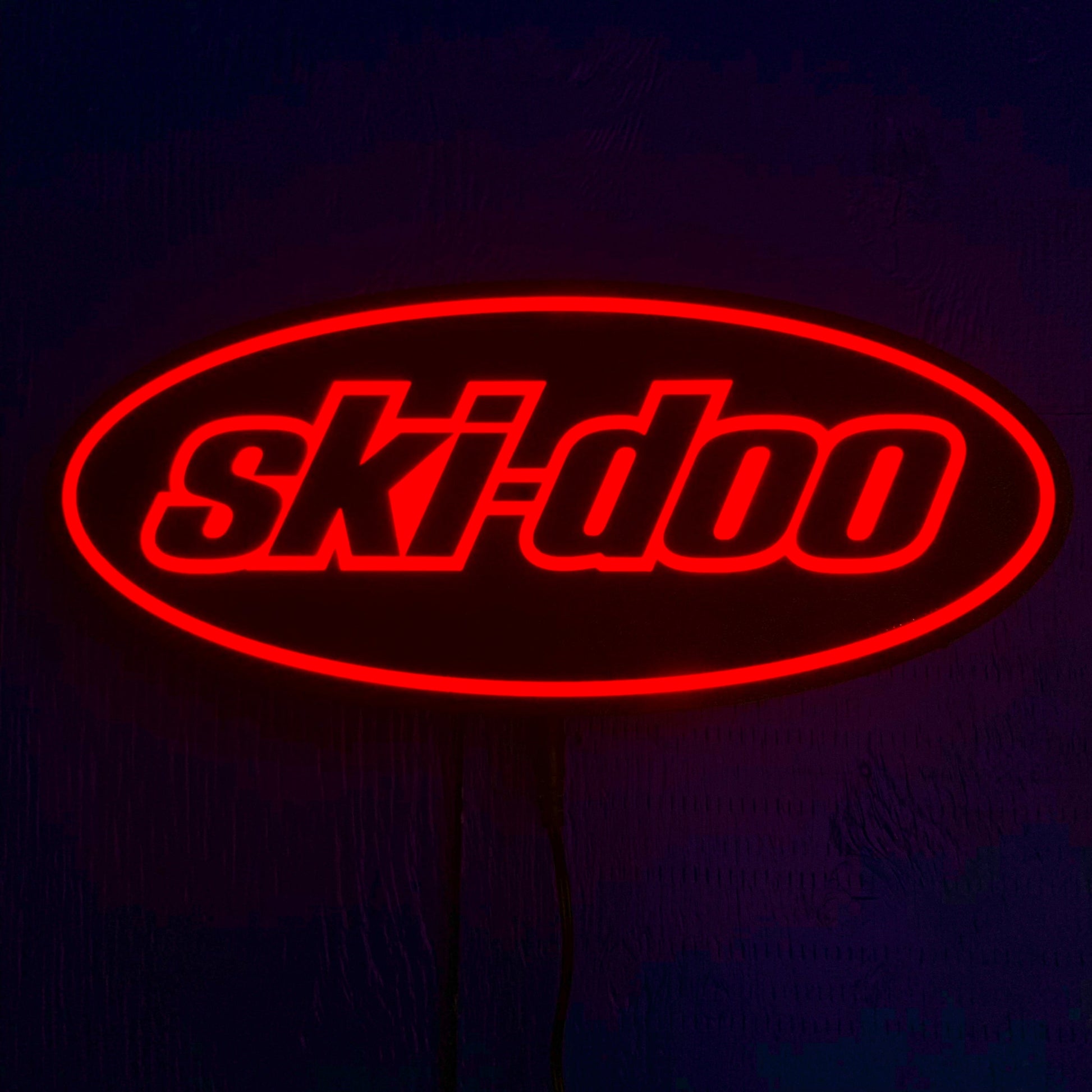 Red 'Ski-doo' led sign on a dark background