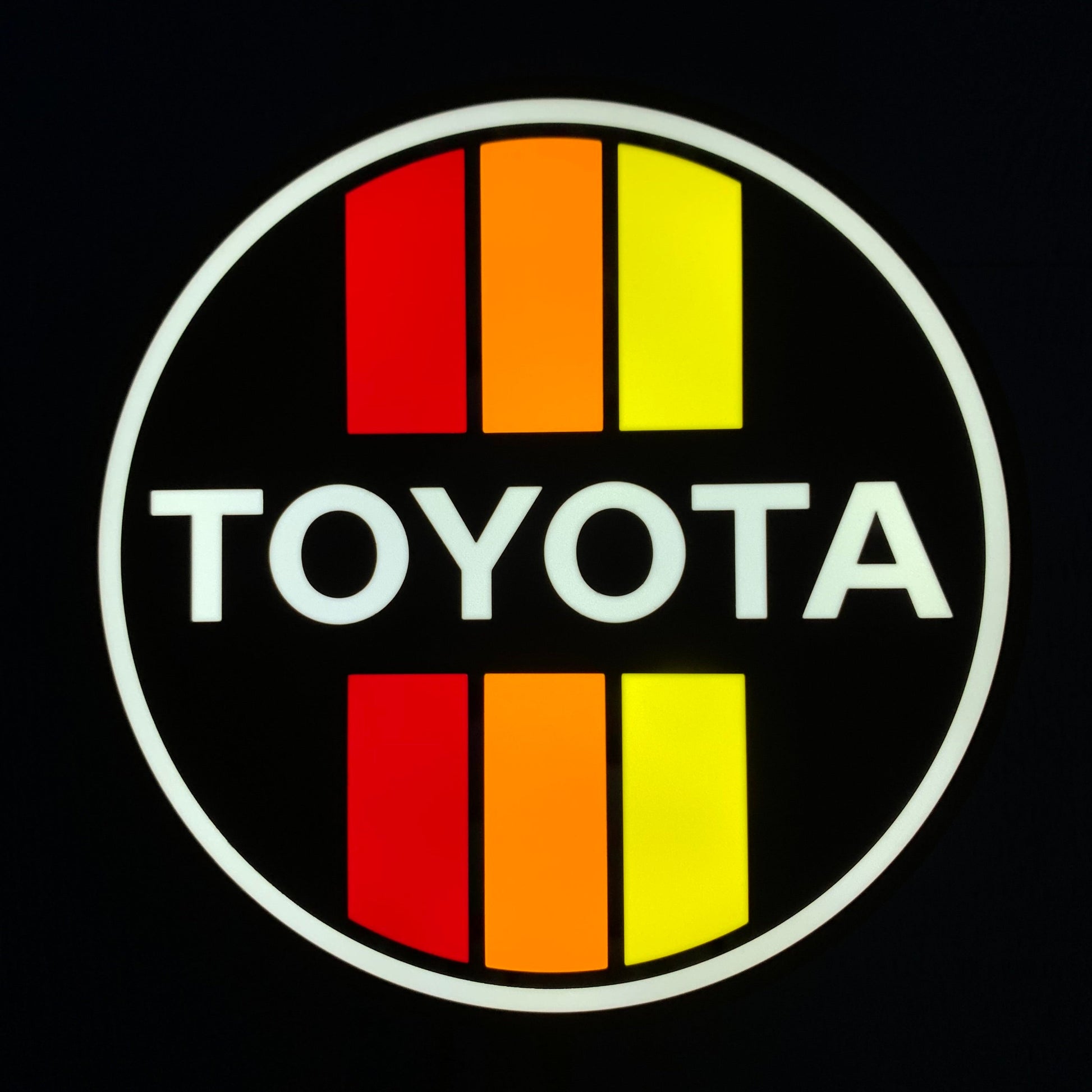 Toyota led indoor sign with red and yellow stripes on a black background