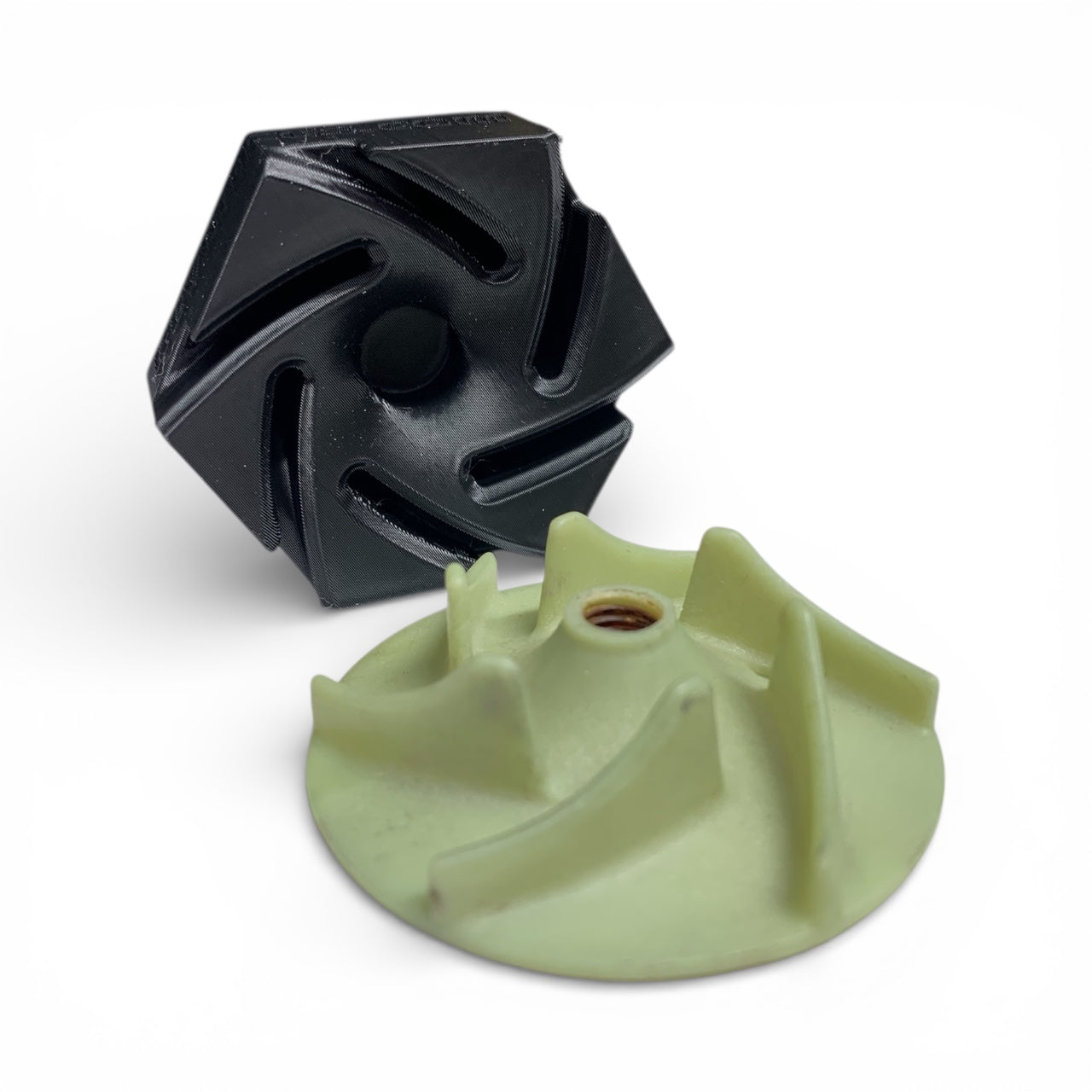 Black and green plastic components on a white background